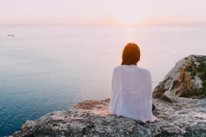 sitting overlooking beach at sunset